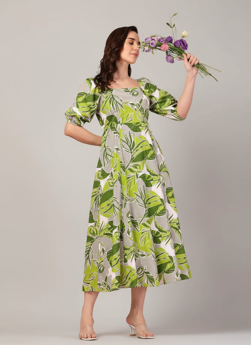 Model wearing green tropical print midi dress with puff sleeves – front view